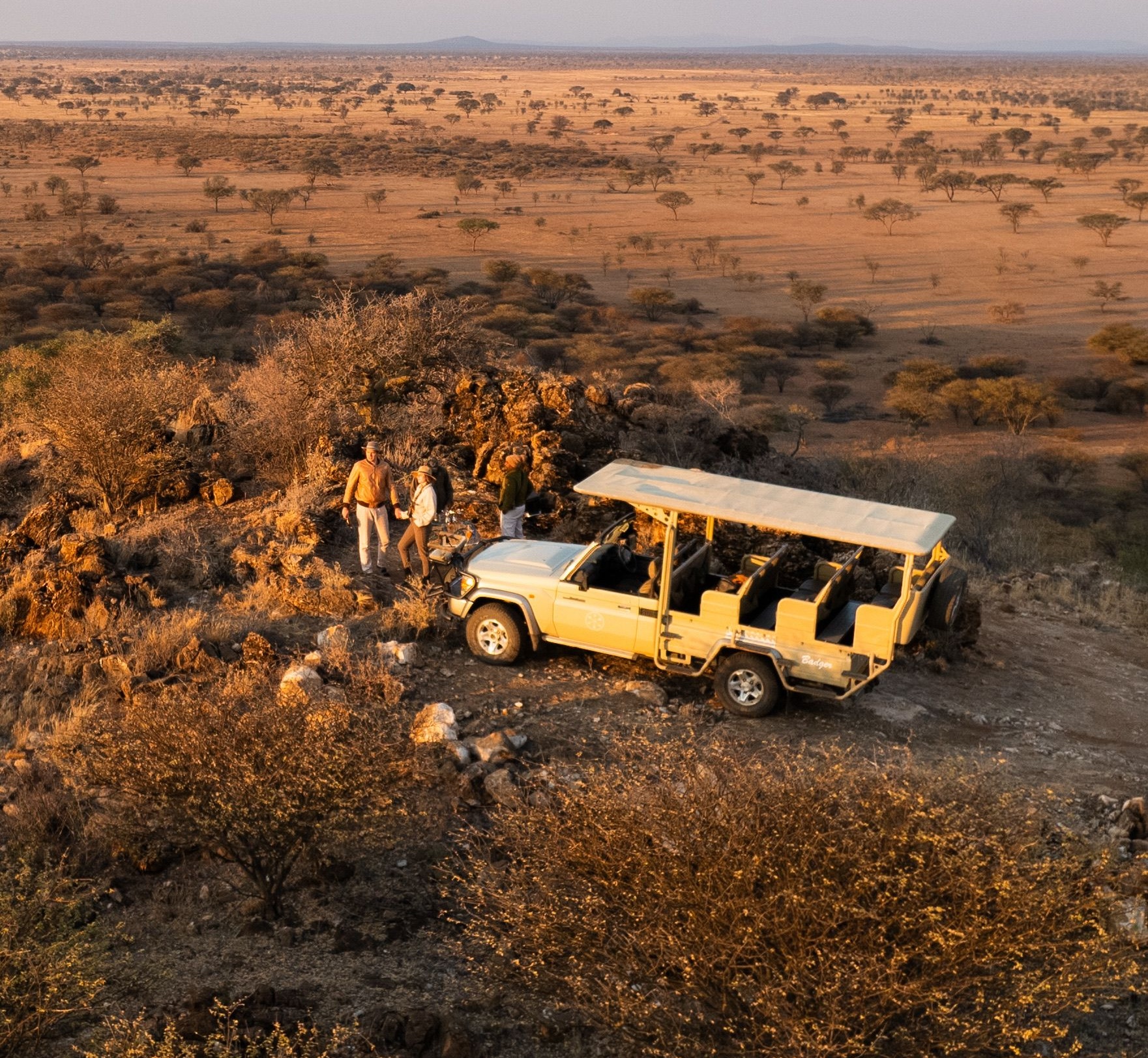 Open safari vehicle on a game drive at dusk